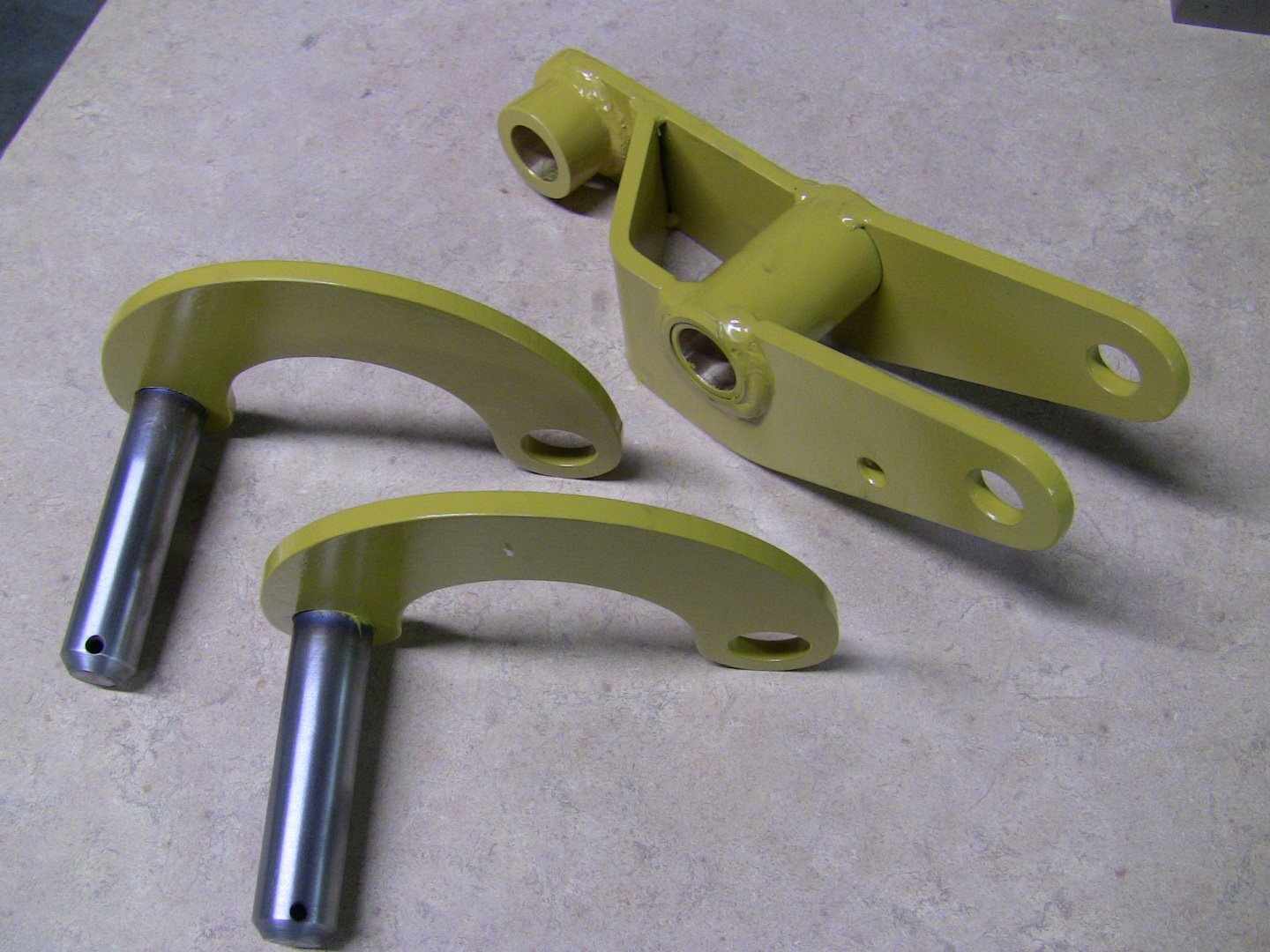 Powder-coated yellow fabricated brackets and pinned arms